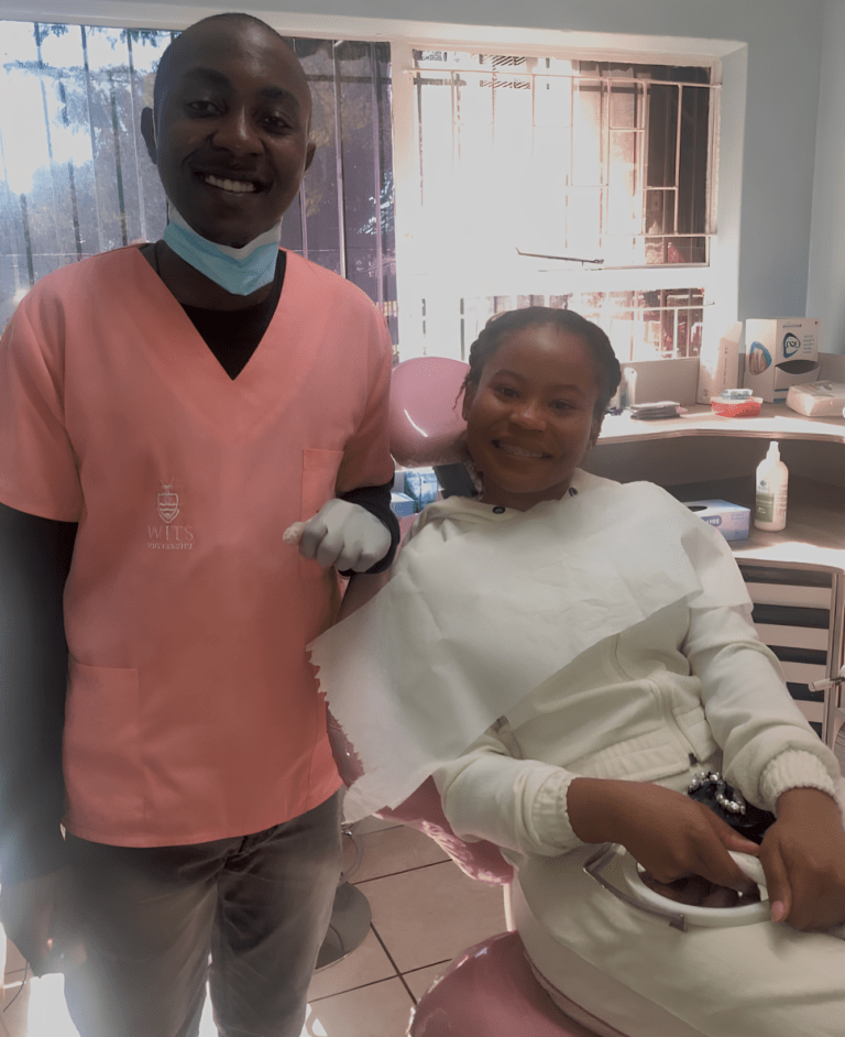 Smiling dentist and patient in a dental clinic after a successful appointment.